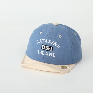 Close-up of baby baseball cap with Catalina 1983 embroidery and yellow brand label