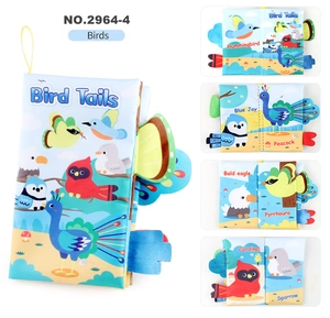 Detail of bird-themed baby cloth book showing colorful 3D tails and cartoon illustrations