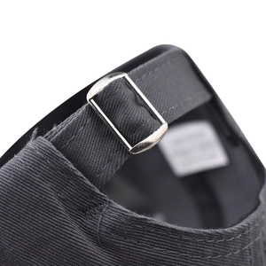 Detail of adjustable metal buckle on dark gray washed cotton baseball cap strap