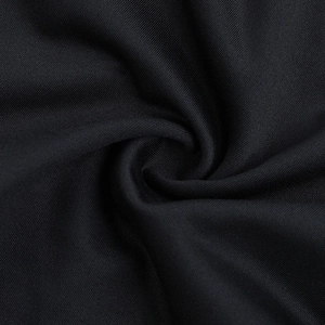 Macro shot of black knitted fabric texture showing premium softness and drape