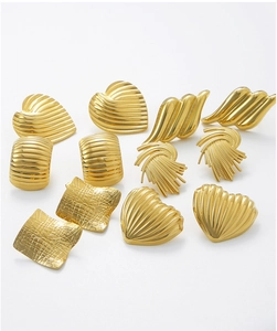 Macro view of gold-plated stainless steel earrings with vintage embossed textures