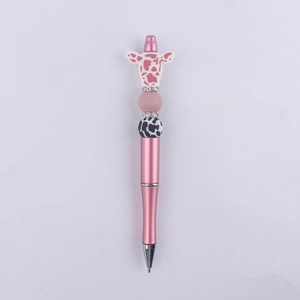 Detail of pink silicone bead pen with cute cow head topper and cow pattern spacer