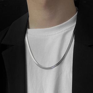 Minimalist 4mm silver flat snake chain necklace in stainless steel worn by a model