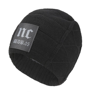 Detail of thermal knit beanie featuring thick faux fur lining and gothic letter patch