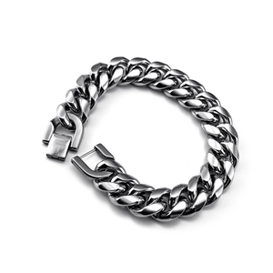 Macro shot of silver Cuban link bracelet with square box clasp and polished finish