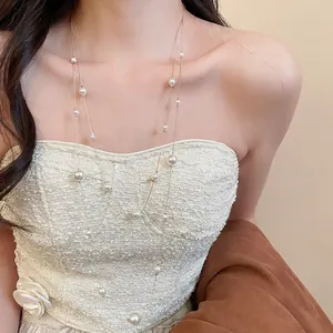 Elegant double-layered pearl necklace with golden chain and white pearls for women