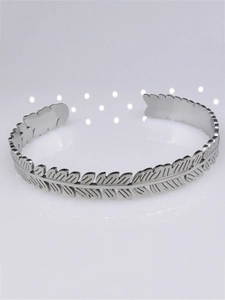 Detailed view of silver laurel leaf cuff bracelet with intricate metallic textures