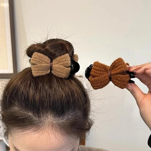 Knitted bow hair claw clips in beige and dark brown, shown in use for elegant updos
