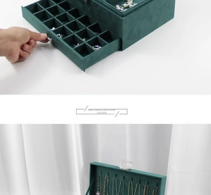 Detail of dark green velvet jewelry box showing necklace hooks and multi-layer drawers