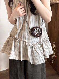 Detail of bohemian round hand-woven crossbody bag with coconut shell and bead accents