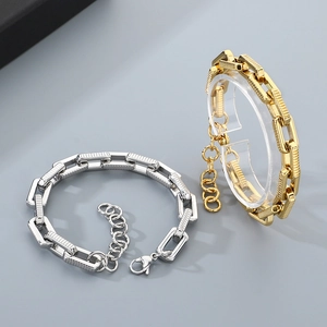 Detailed view of gold and silver rectangular link bracelets with adjustable lobster clasp
