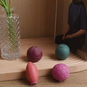 Detailed sports ball scented candles showing realistic textures of football and basketball