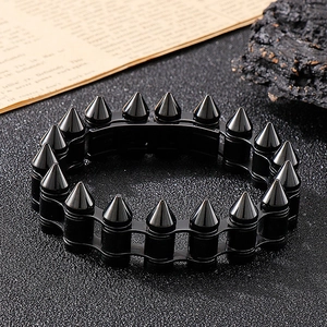 Detail of black punk bullet stud metal chain bracelet for men with edgy rivet texture