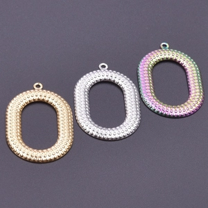 Detailed view of textured oval metal pendants in gold, silver, and rainbow finishes