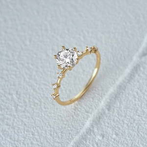 Macro shot of 6-prong luxury ring showing the S925 hallmark and sparkling round diamond