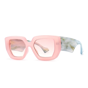 Modern oversized pink square sunglasses with blue marble patterned temples on white background