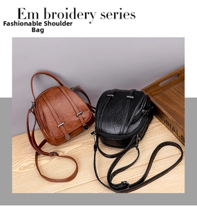 Detail view of retro small crossbody bags in brown and black with soft leather texture