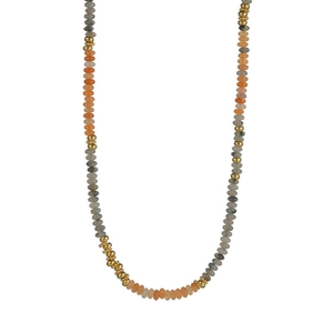 Detail of bohemian beaded necklace with orange, grey and white beads with gold accents