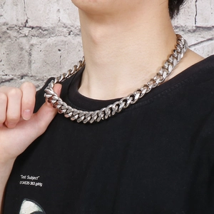 Men's silver stainless steel Cuban link chain necklace on model in streetwear style