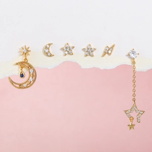 Detail of gold ear stud set with moon and star shapes featuring sparkling zircon accents