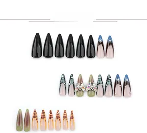 Detail view of press-on nails with 3D crystal butterfly, leopard print, and ombre patterns