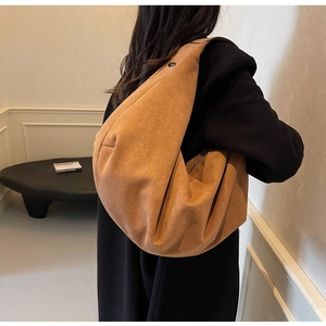 Caramel brown large hobo shoulder bag with a matte suede finish shown on a model