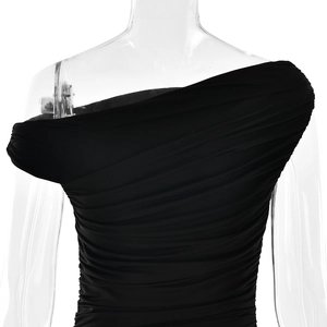 Detail of black one-shoulder dress showing elegant ruched fabric on a mannequin