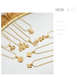 Collection of golden punk animal pendants including crab and spider on a mirror surface