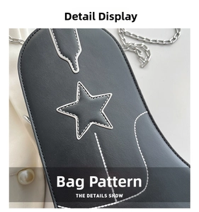 Detail of black leather bag with white star patch and contrast stitching with silver chain