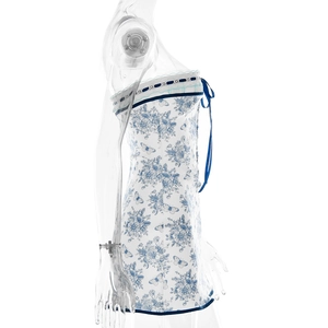 Side view of floral print tube dress with white lace trim and blue bow on white background