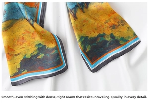 Detailed close-up of premium silk scarf featuring oil painting print and fine rolled edges