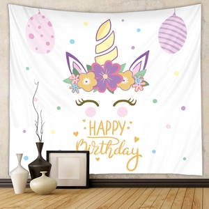 Detail of unicorn themed birthday tapestry with golden happy birthday lettering and flowers