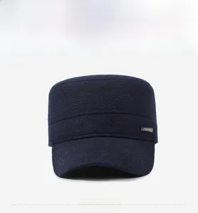 Front view of navy blue flat top cap with fashion metal label and twill texture
