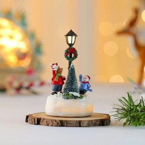 Luminous Christmas resin ornament with bear, snowman and streetlamp on glowing snow base
