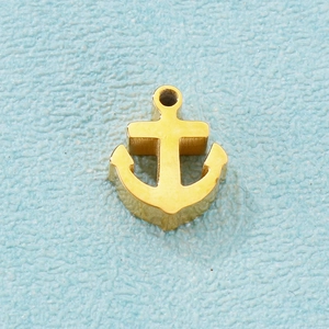 Macro shot of a polished golden stainless steel anchor pendant for DIY jewelry making