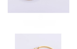 Detail of polished gold stainless steel earring with pavé crystal and white ceramic finish