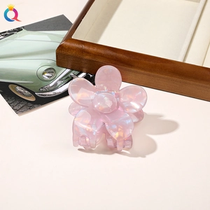Detail of pink floral hair claw with pearlescent finish and smooth acrylic texture