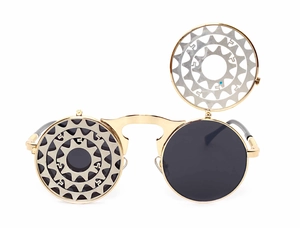 Detail of steampunk flip-up sunglasses with gold metal frame and gear hollow design