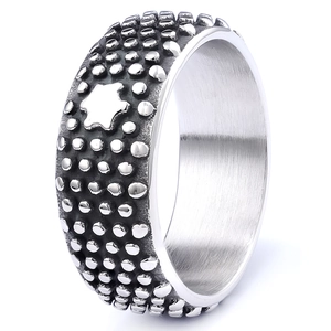 Macro view of wide stainless steel ring with textured pitting and star engraving detail