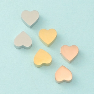 Polished heart-shaped stainless steel beads in silver, gold, and rose gold finishes
