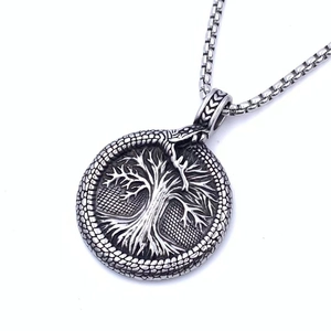 Detailed close-up of a Viking Tree of Life pendant featuring an Ouroboros snake ring