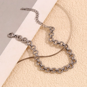 Close-up of chunky silver stainless steel round link chain with lobster clasp detail