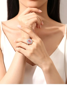 Close-up of a pink gemstone flower ring in S925 silver worn on a finger