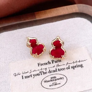 Elegant gold-framed red flocked gourd stud earrings with sparkling diamonds on card