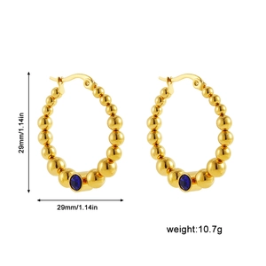 Detailed view of C-shaped gold beaded earrings with blue gemstones and size markings