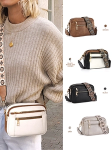 Detail of multi-compartment crossbody bags with colorful bohemian patterned guitar straps