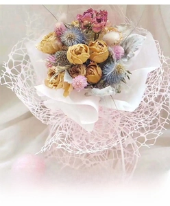 Close-up of dried rose bouquet with jacquard mesh wrap and decorative floral netting