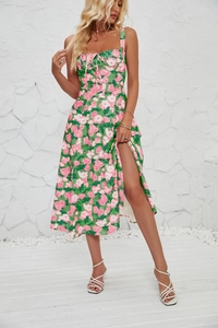 Detail of high side slit and floral print on a green summer sleeveless midi dress