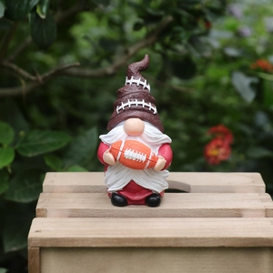 Rugby themed gnome statue garden ornament made of weathered resin for outdoor patio decor