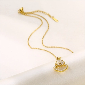 18k gold heart and zircon flower pendant necklace on a soft white textured background